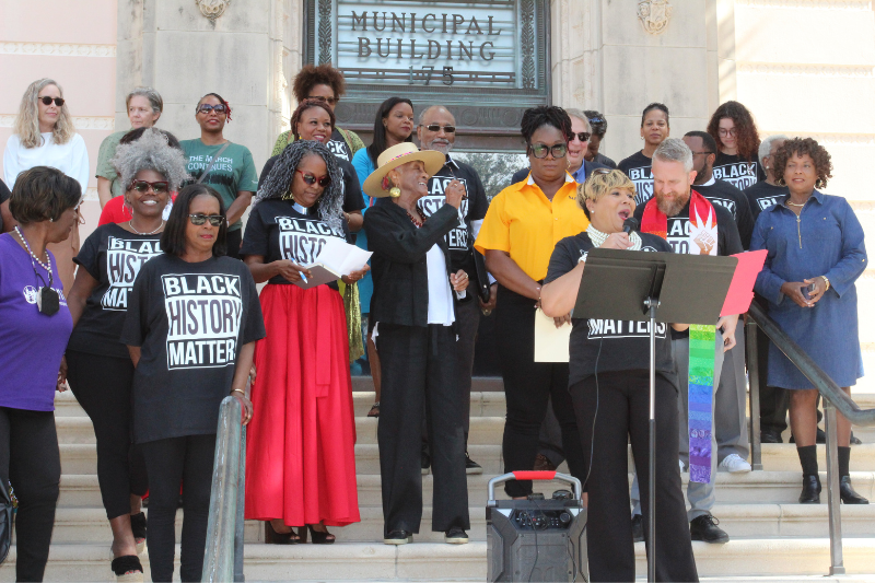 Image Credit: The Weekly Challenger, featured is Terri Lipsey-Scott speaking at the steps of City Hall 