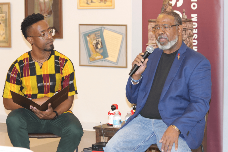 Patrick Jackson, (left), manager of education and outreach at the Woodson Museum and curator Dr. Cody L. ‘Spec’ Clark discussing the artifacts in the ‘Resilience & Revolution: An Immersion of Black Americana’ collection.